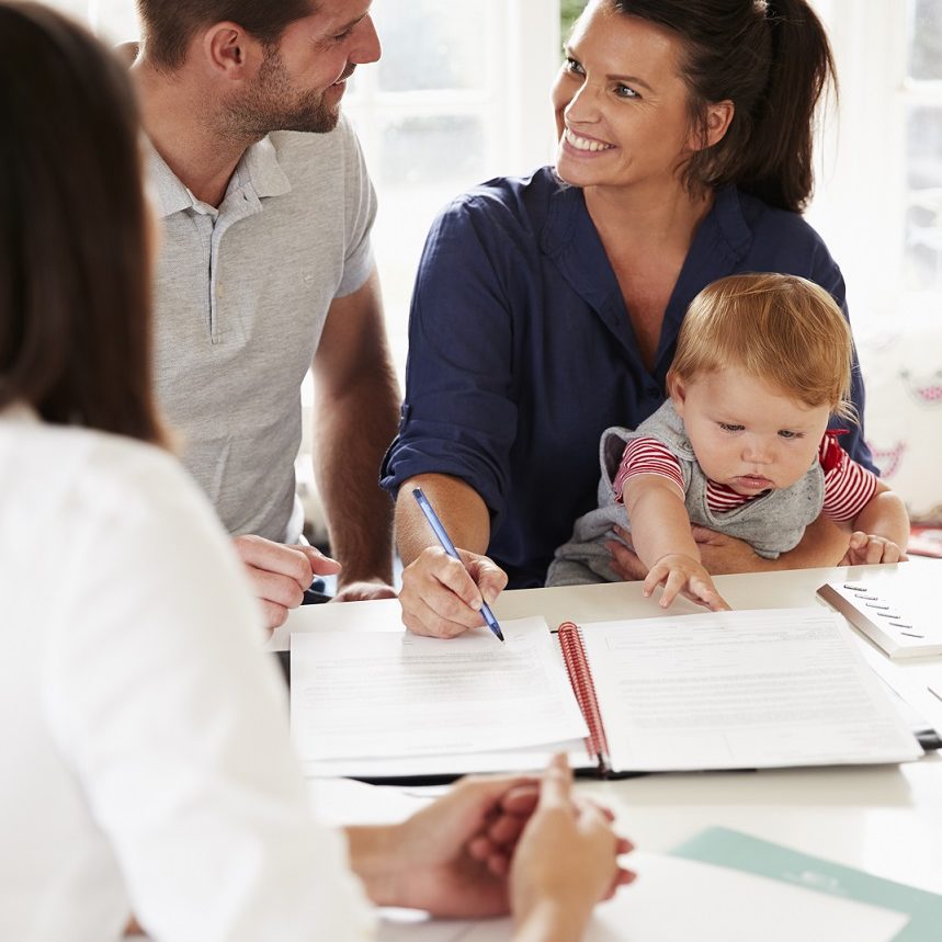 Family With Baby Meeting Financial Advisor At Home